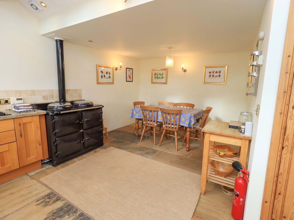 A kitchen with dining area featuring a table and chairs at Usherwoods Barn in Tatham