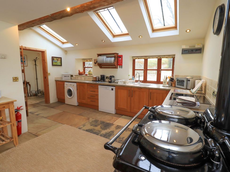 A kitchen with appliances and countertops at Usherwoods Barn Tatham