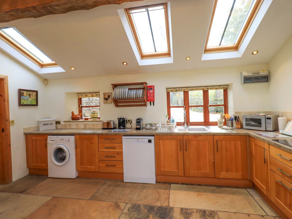 A kitchen with appliances and countertops at Usherwoods Barn Tatham