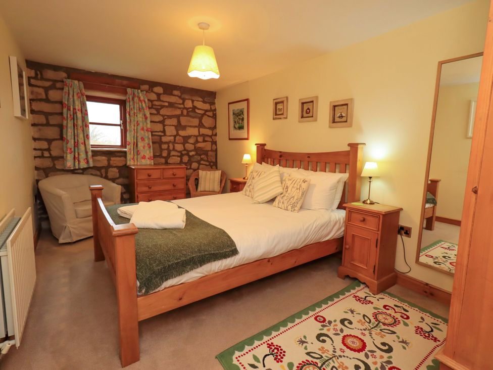 A bedroom with a bed and bedside table at Usherwoods Barn in Tatham