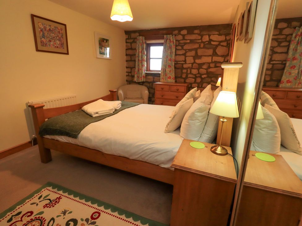 A bedroom with a bed and dresser at Usherwoods Barn Tatham