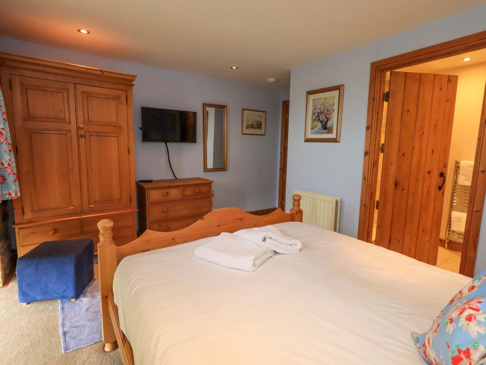 A bedroom with a bed and wardrobe at Usherwoods Barn in Tatham