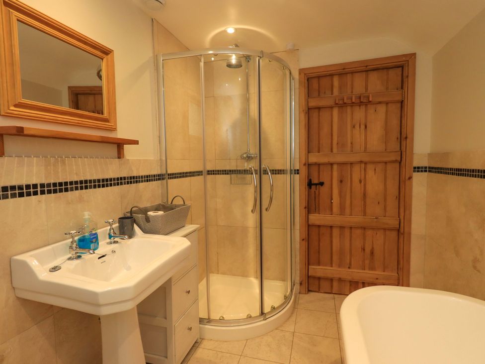 A bathroom with a shower, sink, and bathtub at Usherwoods Barn Tatham