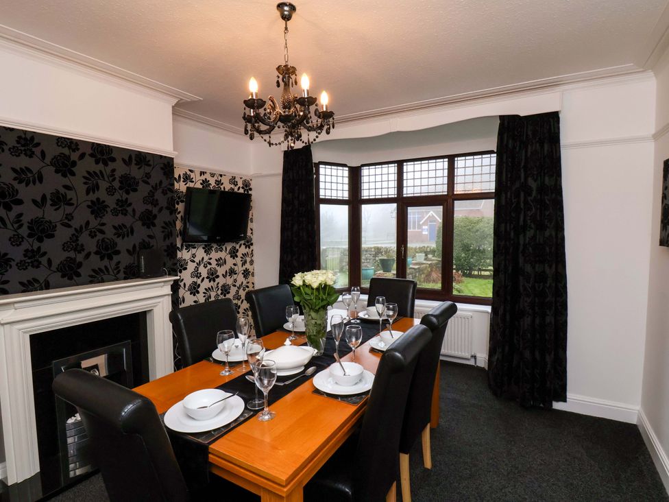 A dining room with a table set for dinner at Dilston House in Goathland