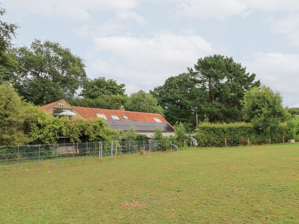 A building surrounded by grass and trees at Uplands in Over Compton near Sherborne