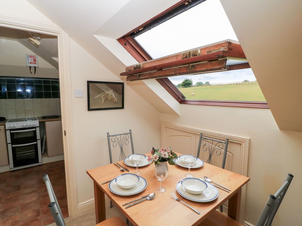 A dining area with a table set for a meal at Uplands Over Compton near Sherborne