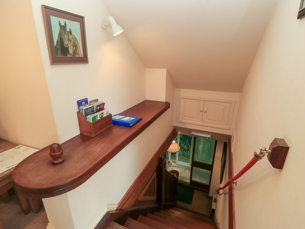 A staircase with a shelf and brochures at Uplands Over Compton near Sherborne