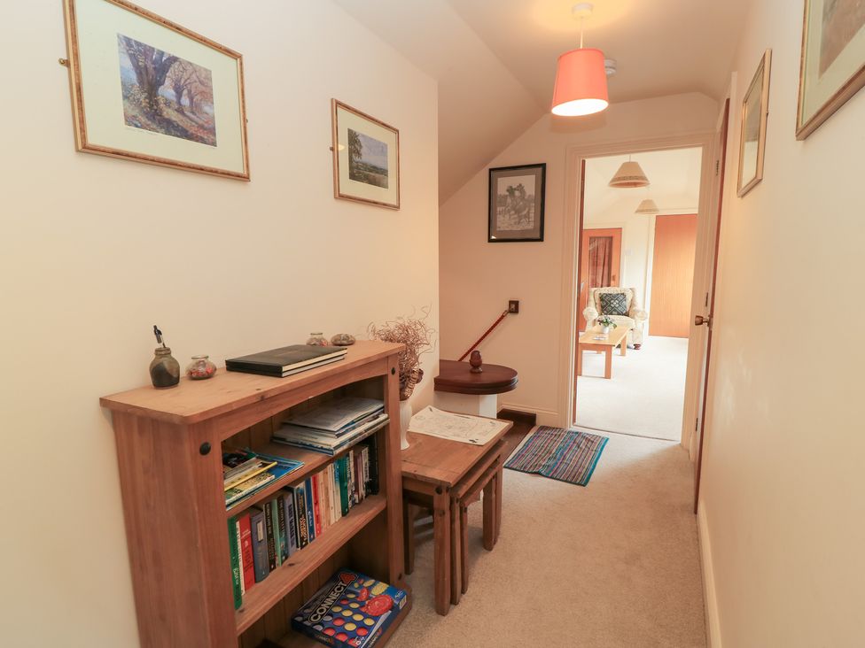 A hallway with a bookcase and a table at Uplands Over Compton near Sherborne