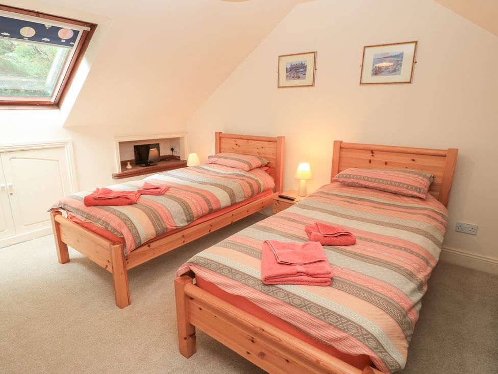 A bedroom with two beds and a window at Uplands Over Compton near Sherborne