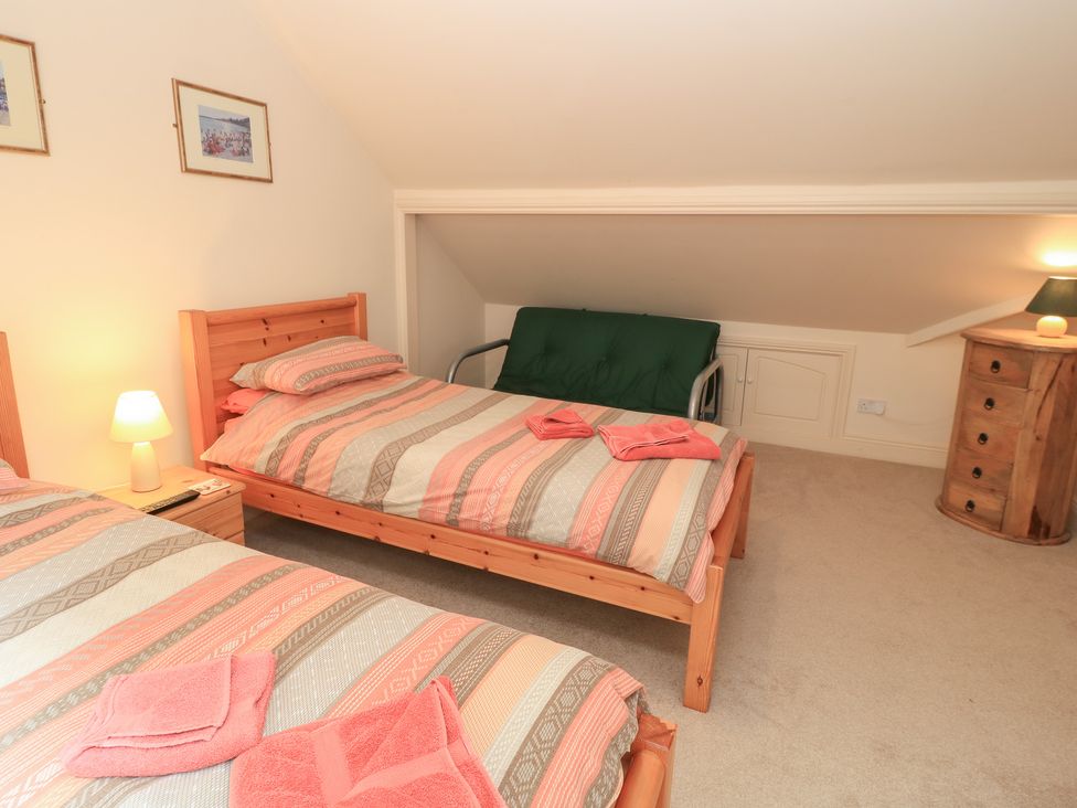 A bedroom with two beds and a sofa bed at Uplands Over Compton near Sherborne