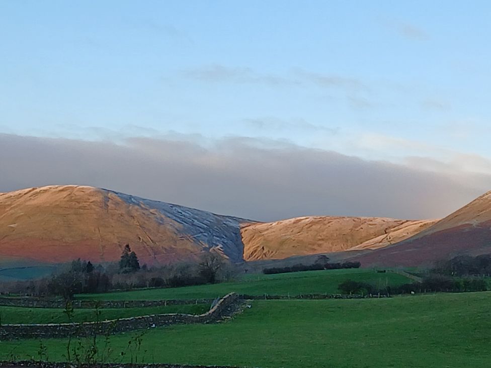 A view of mountains and grassy landscape at Riddings Barn Howgill near Sedbergh