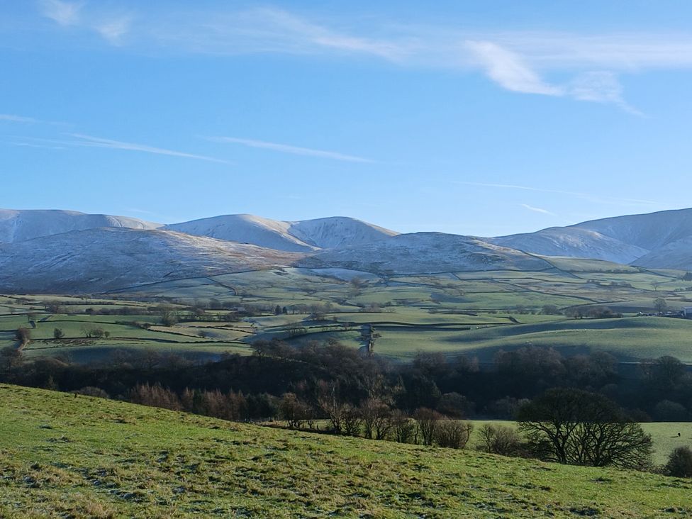 A landscape with mountains and fields at Riddings Barn Howgill near Sedbergh