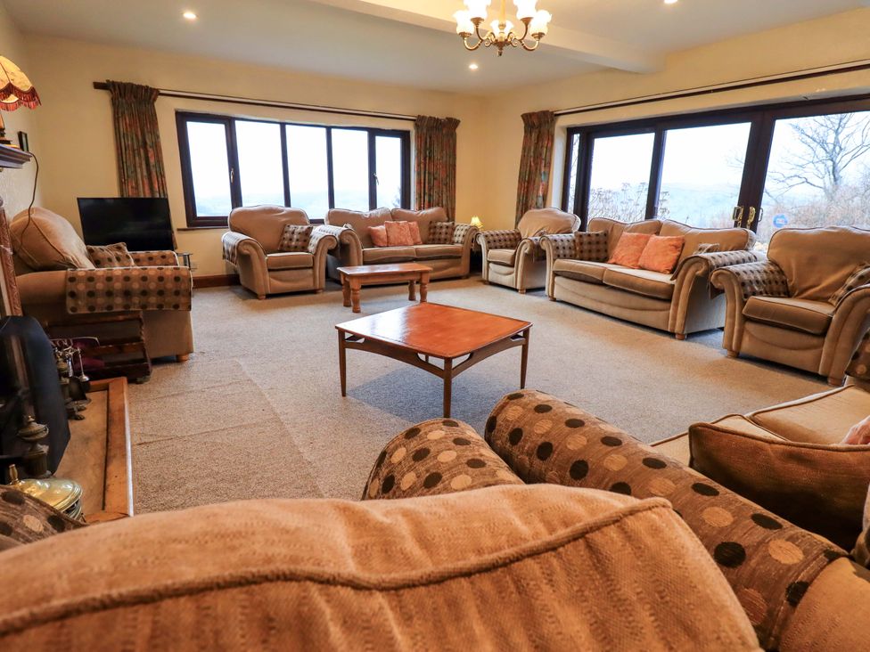 A living room with sofas and a coffee table at Ghyll Bank House Staveley near Windermere
