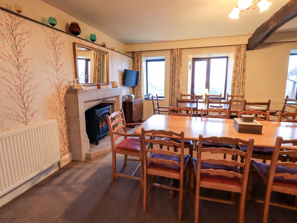 A dining room with a table and chairs at Ghyll Bank House in Staveley near Windermere