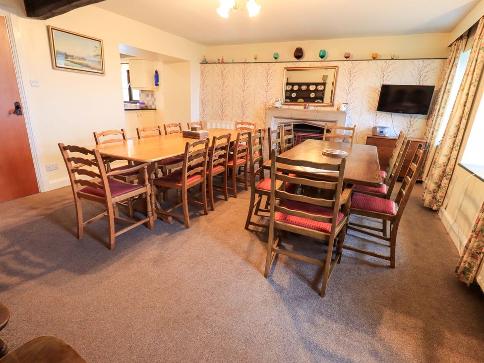 A dining room with tables and chairs at Ghyll Bank House Staveley near Windermere
