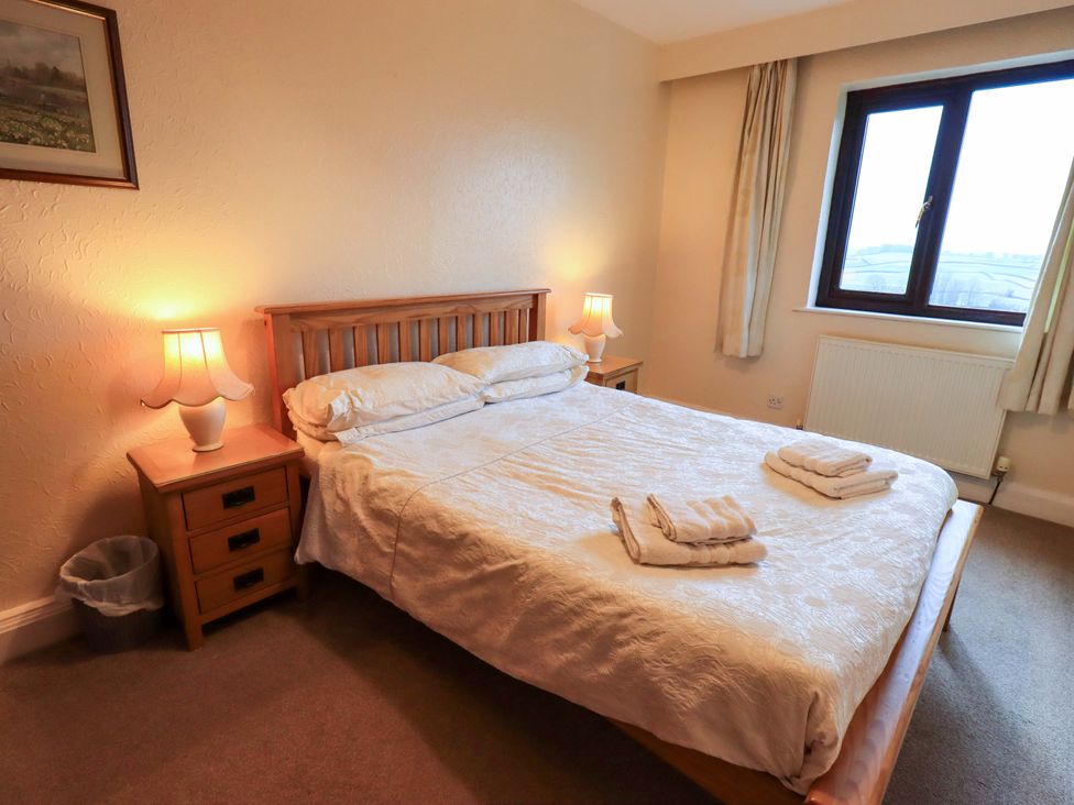 A bedroom with a bed and nightstand at Ghyll Bank House Staveley near Windermere