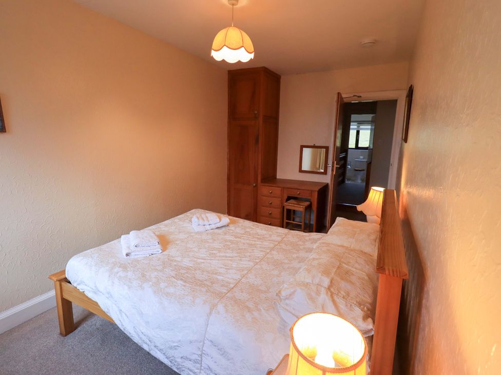 A bedroom with a bed and furniture at Ghyll Bank House Staveley near Windermere