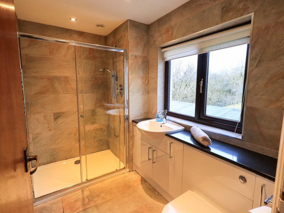 A bathroom with a shower and wash basin at Ghyll Bank House Staveley near Windermere