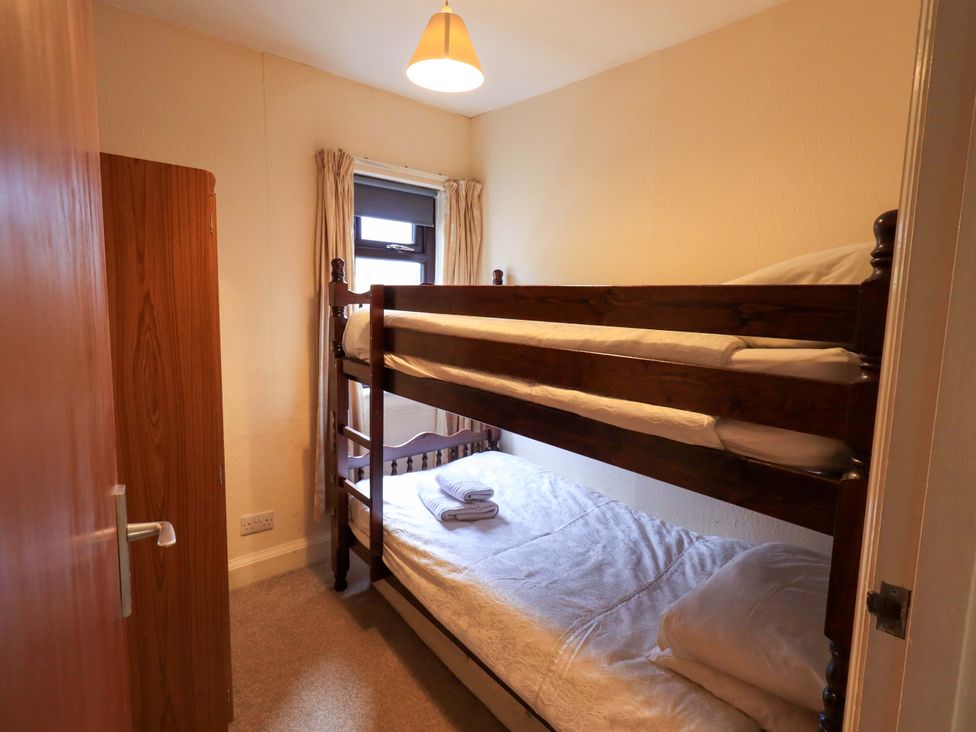 A bedroom with a bunk bed and a window at Ghyll Bank House Staveley near Windermere
