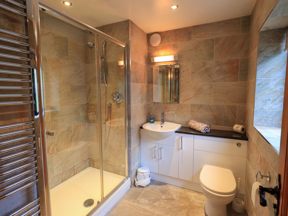 A bathroom with shower and sink at Ghyll Bank House Staveley near Windermere