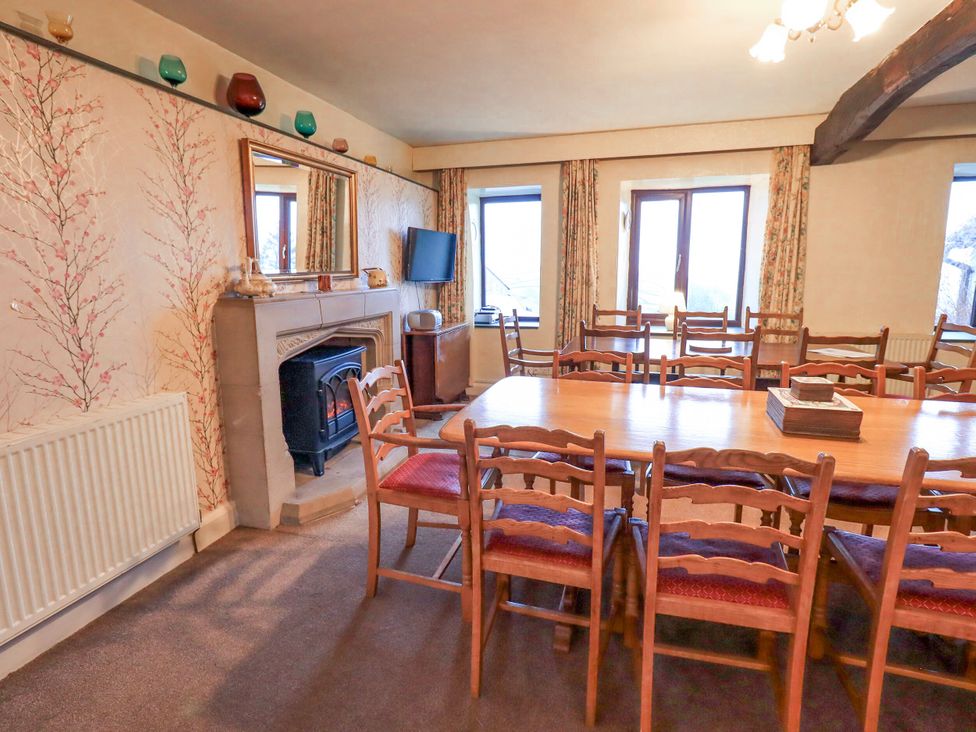 A dining room with a large table and chairs at Ghyll Bank House Staveley near Windermere