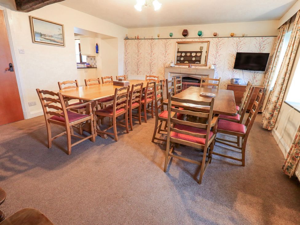 A dining room with tables and chairs at Ghyll Bank House Staveley near Windermere