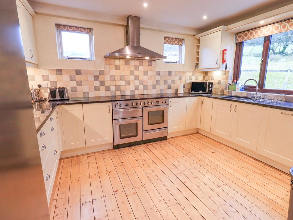 A kitchen with an oven and countertop at Ghyll Bank House Staveley near Windermere