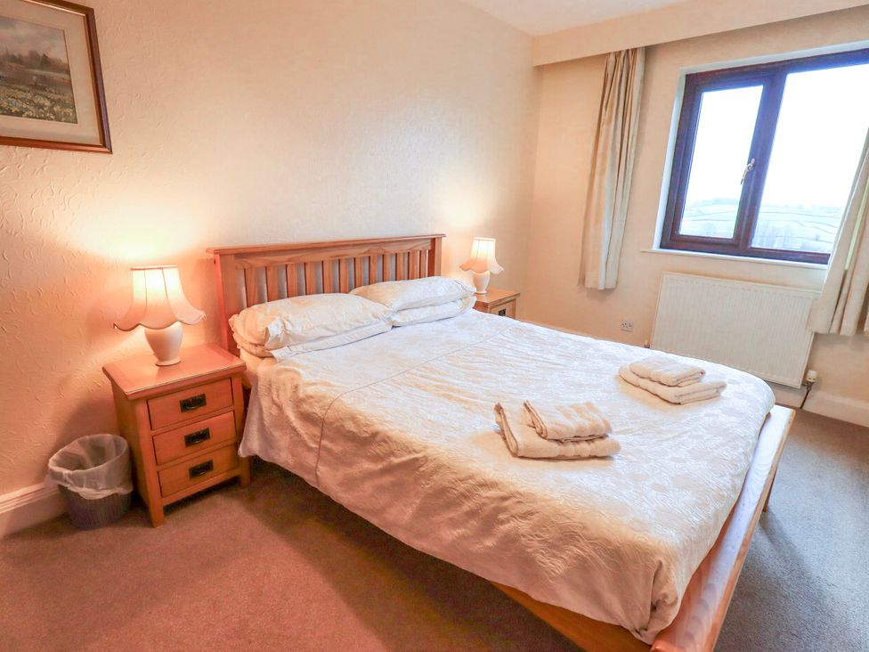 A bedroom with a bed and nightstand at Ghyll Bank House Staveley near Windermere