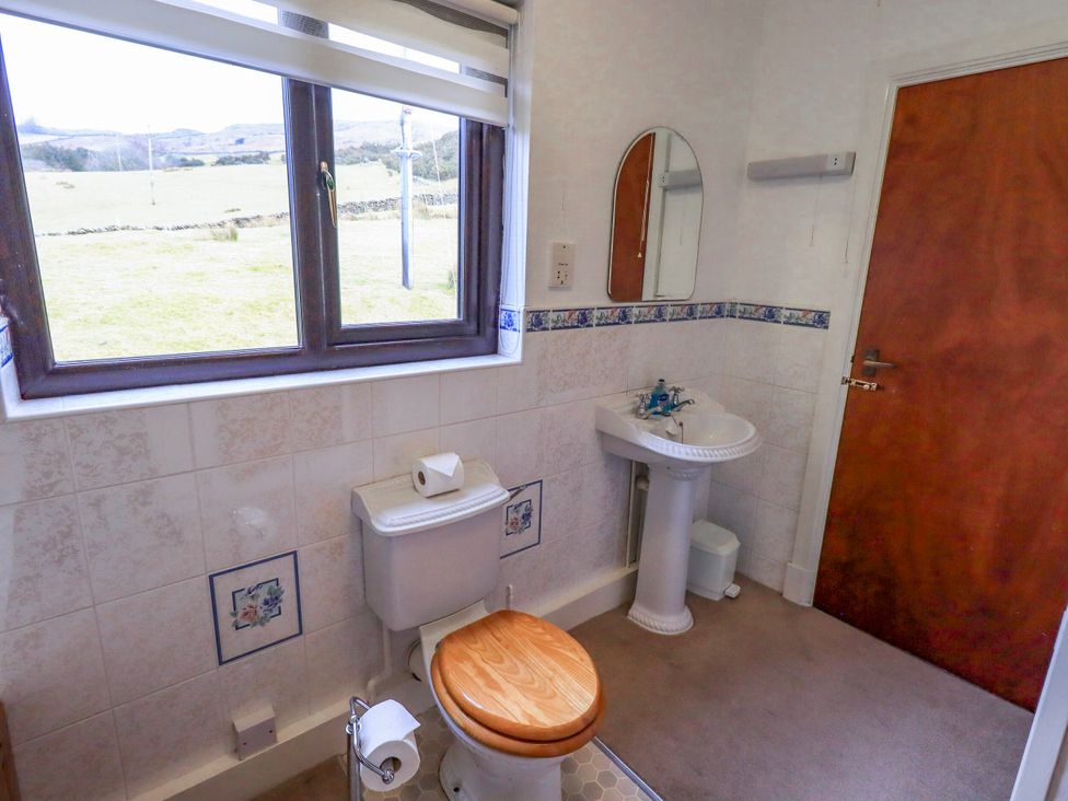 A bathroom with a toilet and sink at Ghyll Bank House in Staveley near Windermere