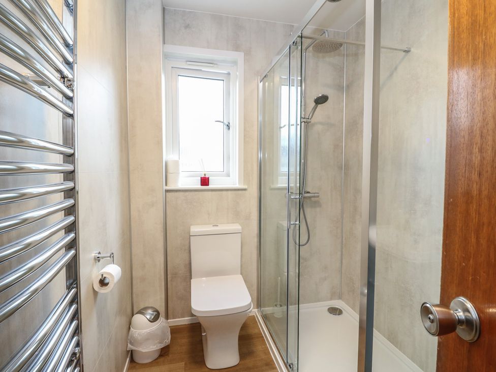 A bathroom with a toilet and shower at Steam Cottage in Aviemore