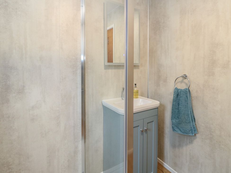A bathroom with a sink and shower at Steam Cottage in Aviemore