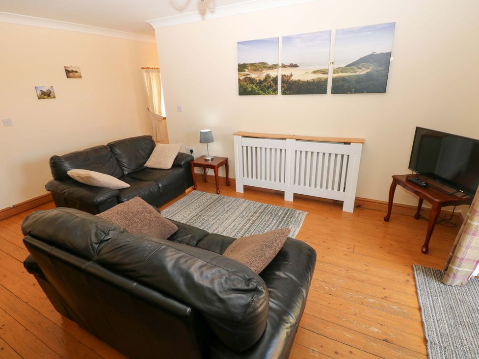 A living room with sofas and a television at The Stall in Penuel near Llanmorlais