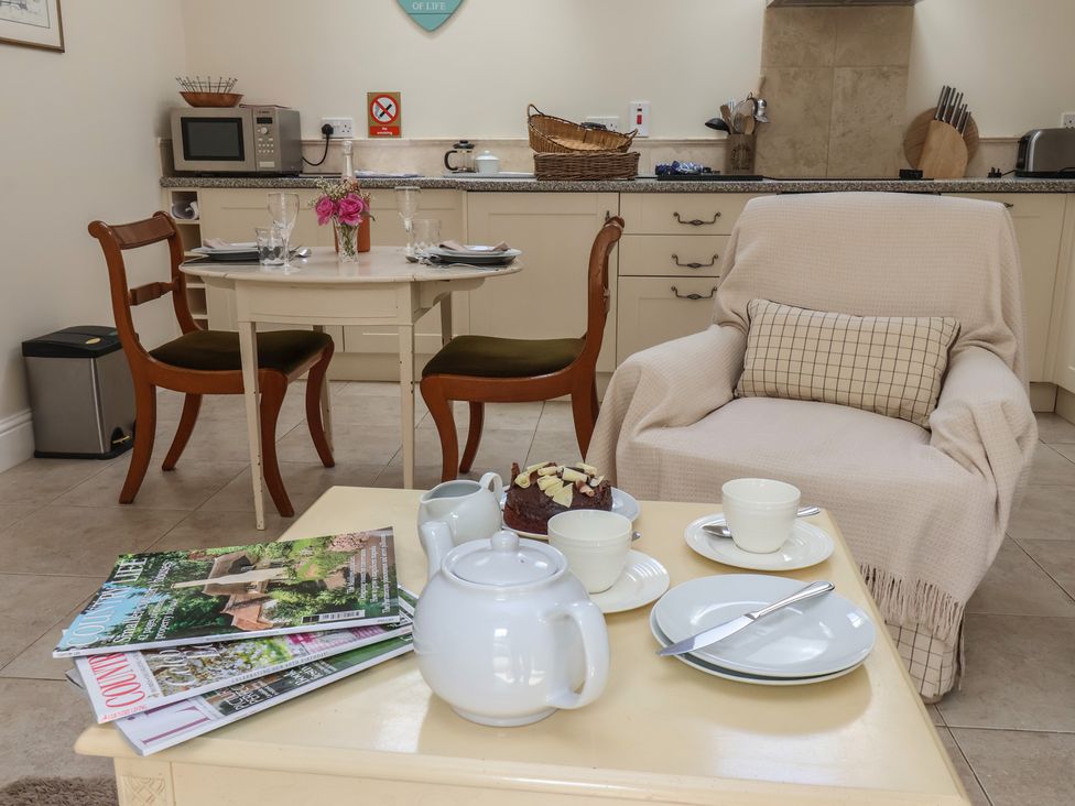 A kitchen with a table and chairs in Stable Cottage Cawton near Hovingham