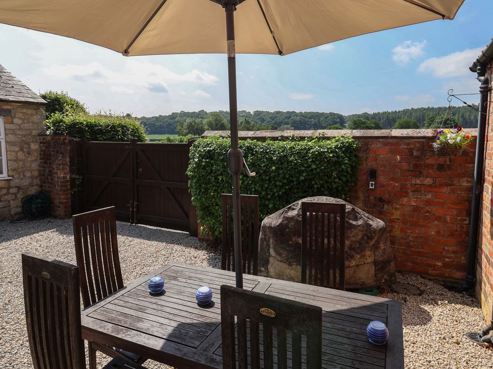 An outdoor dining area with table and chairs at Stable Cottage Cawton near Hovingham