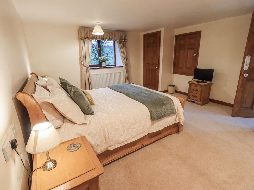 A bedroom with bed and television at Christine's Stable in Shap near Maulds Meaburn