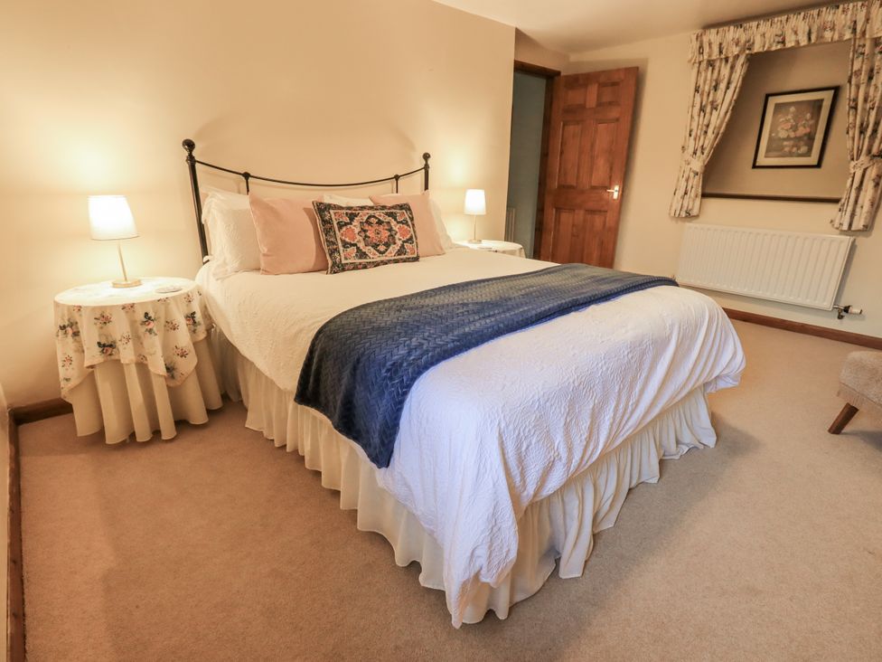 A bedroom with a bed and bedside tables at Christine's Stable in Shap near Maulds Meaburn