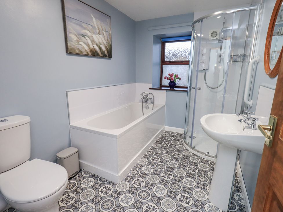 A bathroom featuring a shower, bathtub, and sink at Christine's Stable in Shap near Maulds Meaburn