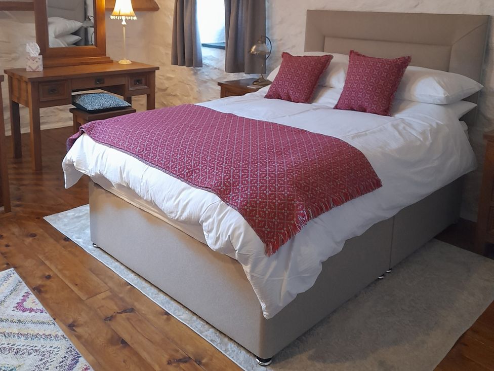 A bedroom with a bed and desk at Y Bwthyn in Ysbyty Ifan