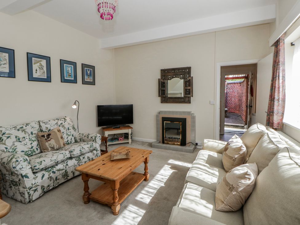 A living room with a sofa and coffee table at Riverside Cottage near Llanwrthwl