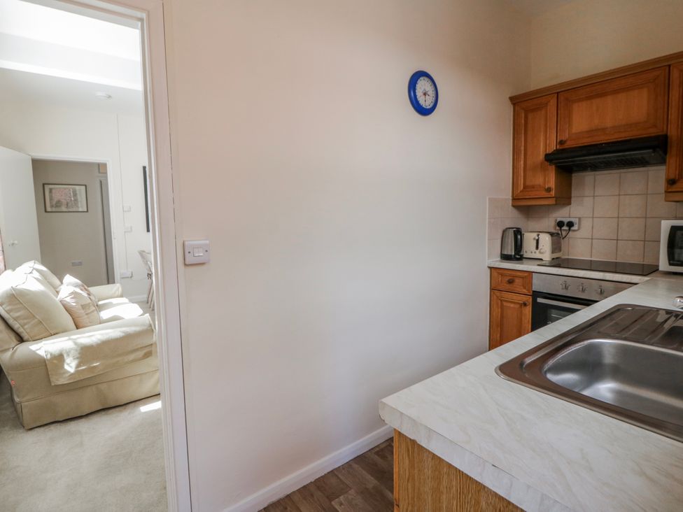 A kitchen with a sink and stove at Riverside Cottage in Llanwrthwl near Rhayader