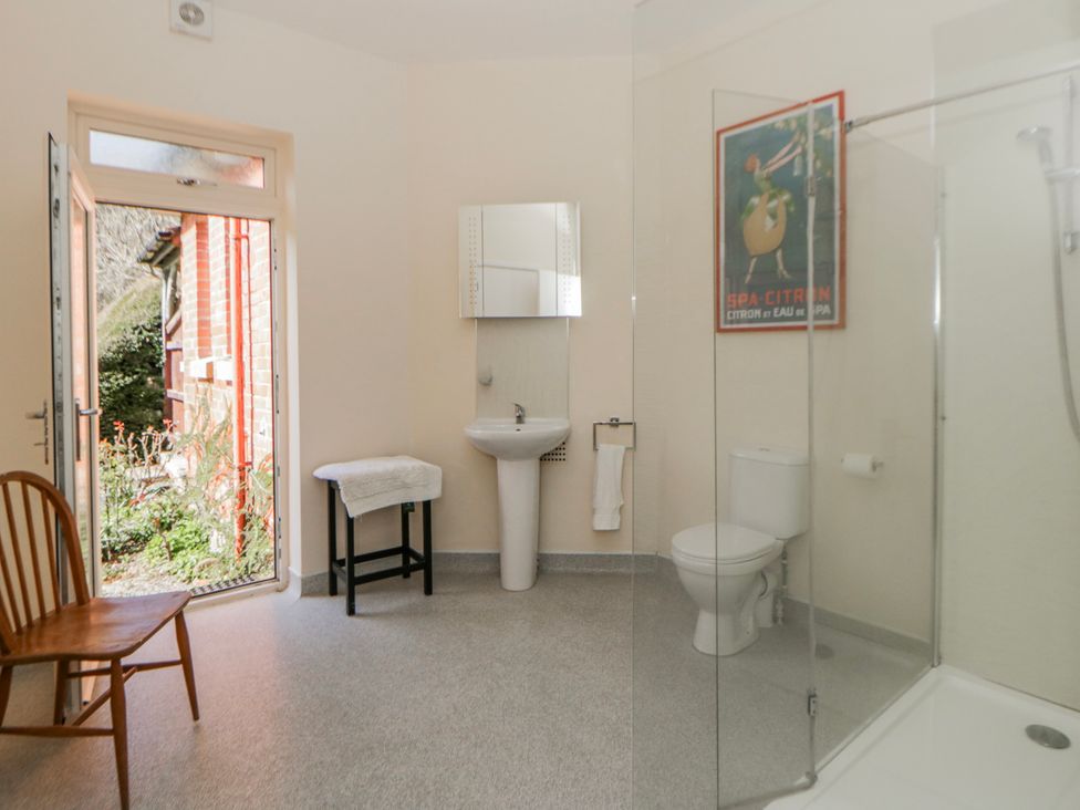 A bathroom with a sink and shower at Riverside Cottage in Llanwrthwl near Rhayader