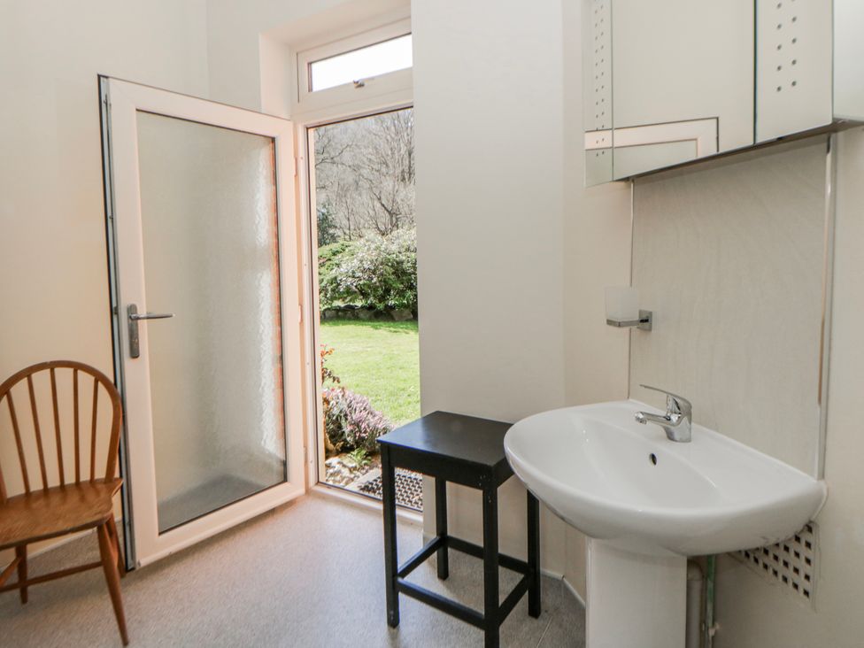A bathroom with a sink and mirror at Riverside Cottage near Llanwrthwl