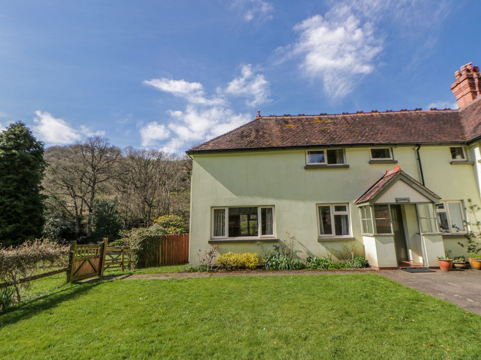 A house with a garden and pathway at Gardener's Cottage in Llanwrthwl near Rhayader