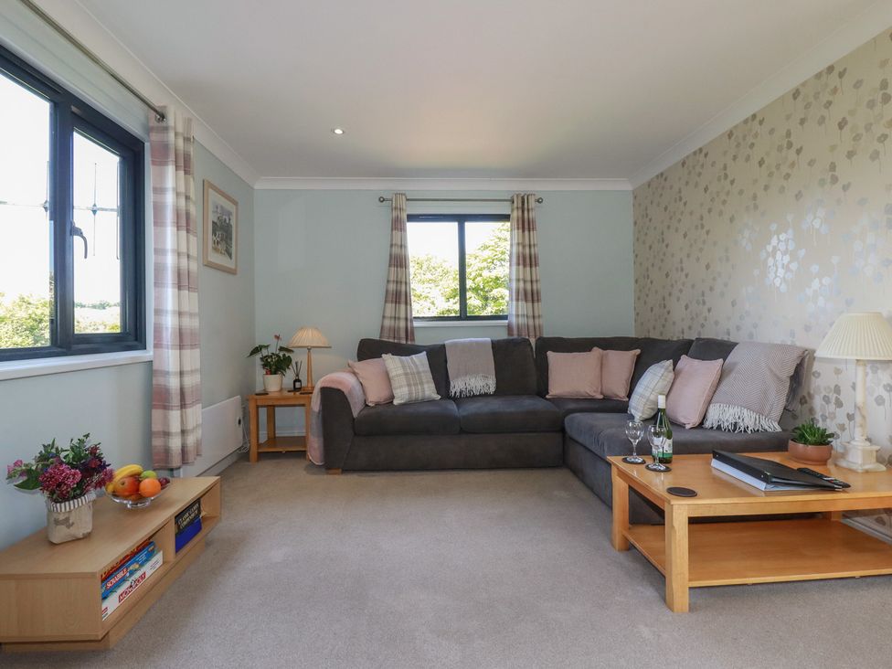 A living room with a sofa and table at The Station Flat St Newlyn East near Newquay