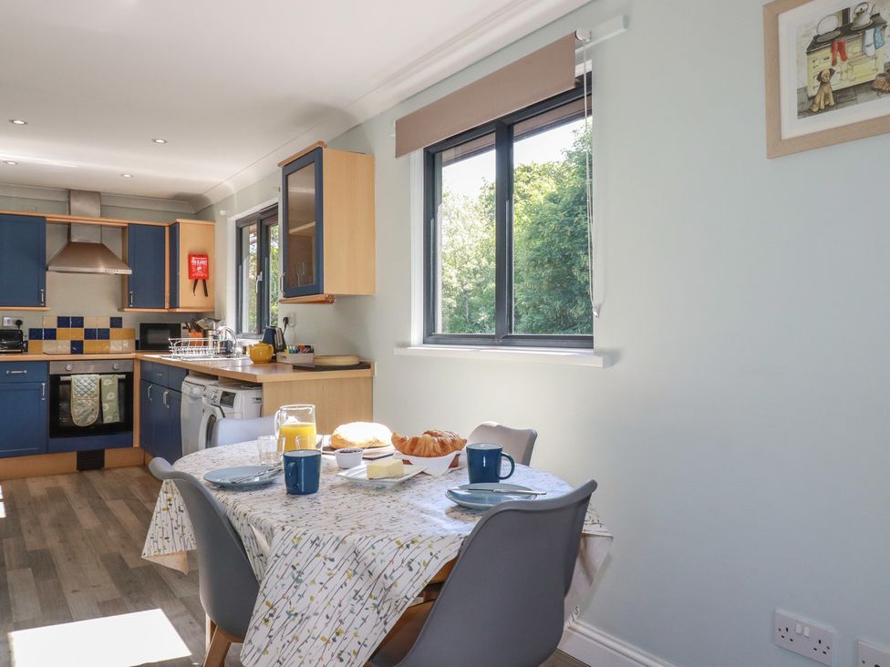 A kitchen with a dining table and breakfast items at The Station Flat in St Newlyn East near Newquay