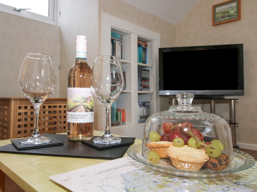 A living room with wine and snacks on a table at Southview in Clee Hill near Ludlow