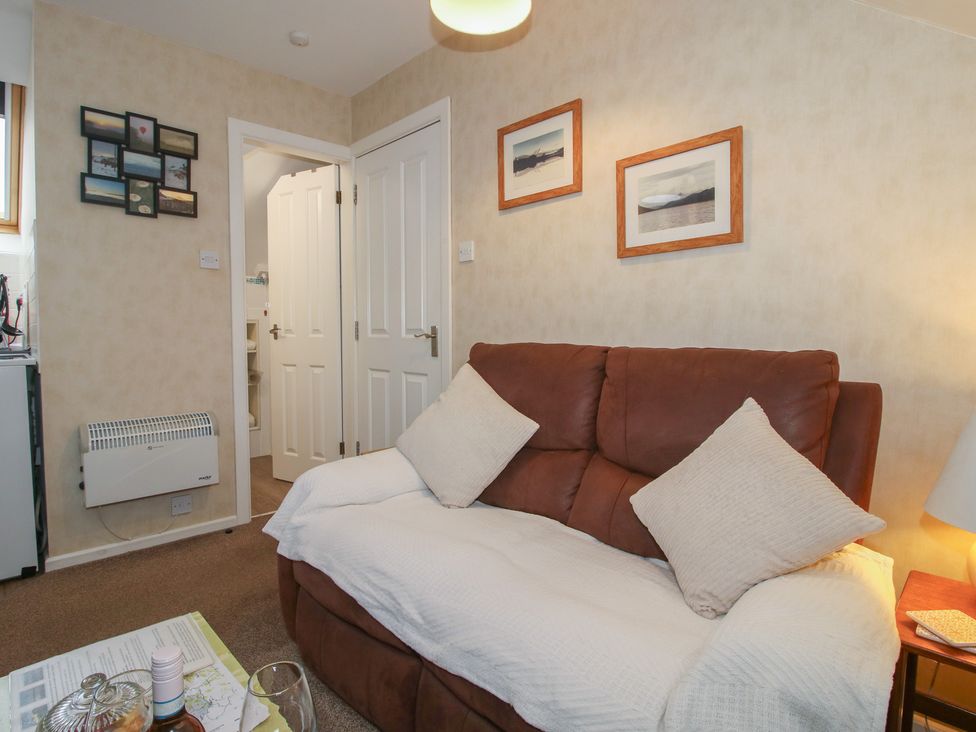 A living room with a sofa and pictures on the wall at Southview in Clee Hill near Ludlow
