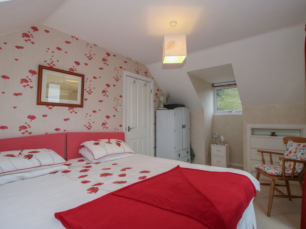 A bedroom with a bed and wardrobe at Southview in Clee Hill near Ludlow