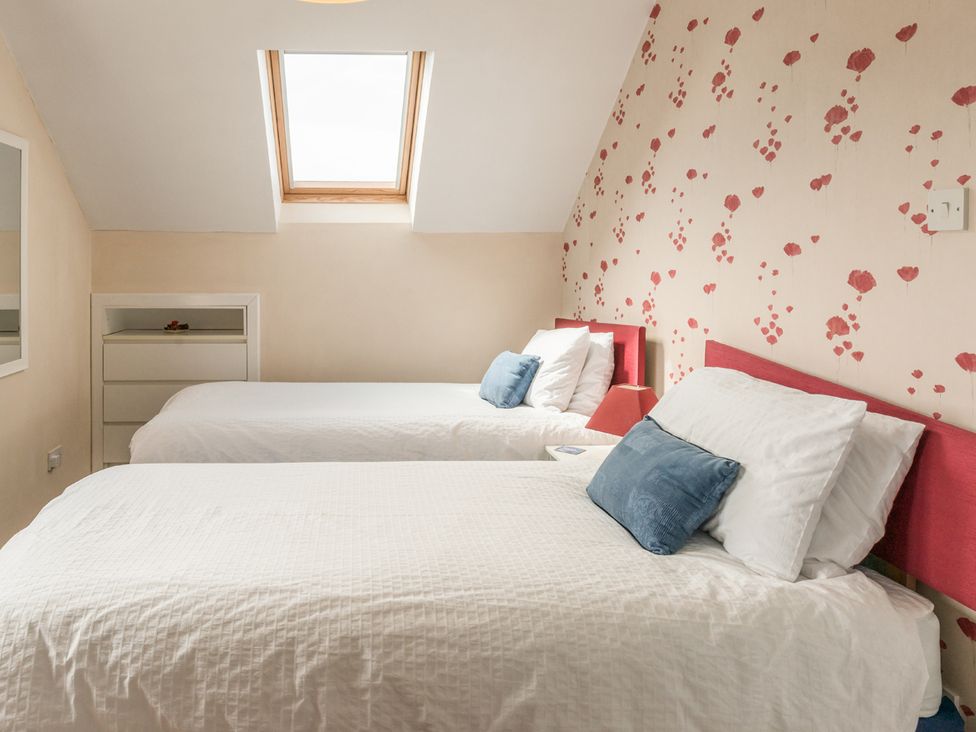 A bedroom with two beds and a skylight at Southview in Clee Hill near Ludlow