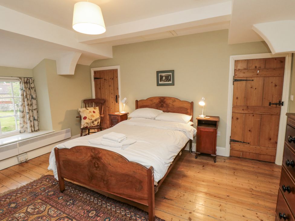A bedroom with a bed and nightstand at Brookleigh in Hutton-le-Hole